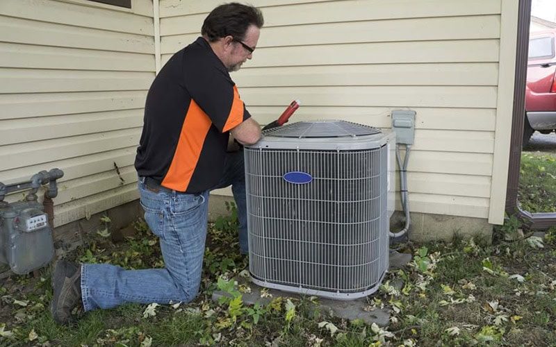 repair man checking ac unit