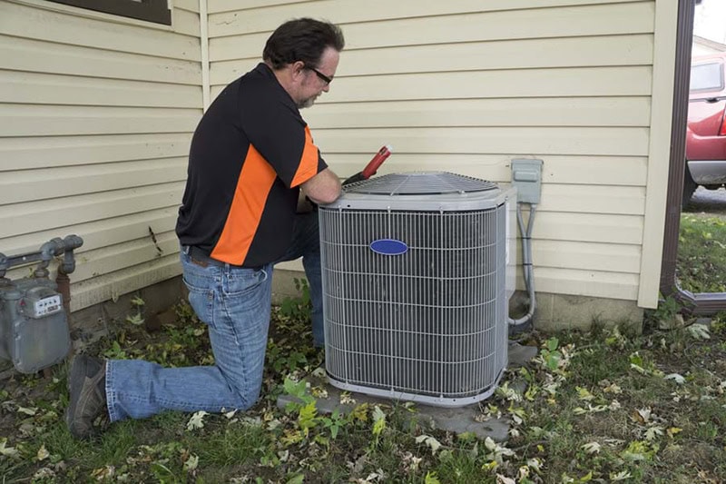 repair man checking ac unit