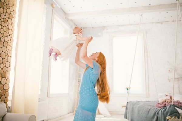 Mom and daughter one year old in a room with good indoor air quality.|