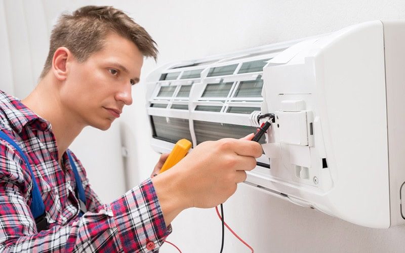 man looking at ductless unit