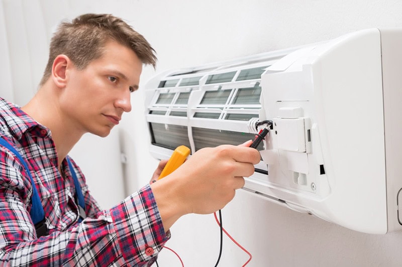 man looking at ductless unit