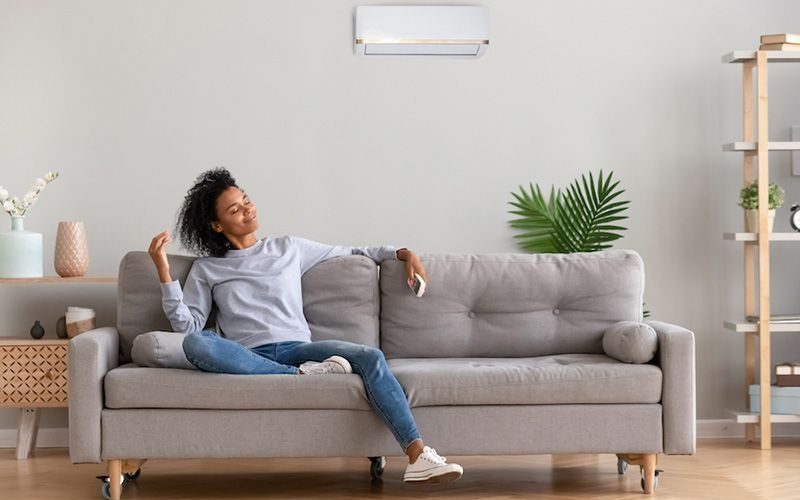What Accessories Can Help With My Indoor Air Quality? Image woman sitting on a couch.