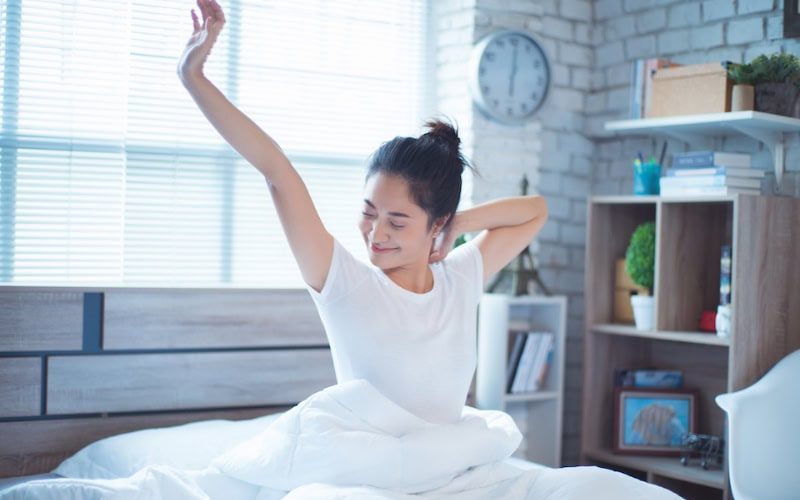 Your HVAC System Can Enhance Sleep. Asian women She is in bed and was waking up in the morning. She felt very refreshed.