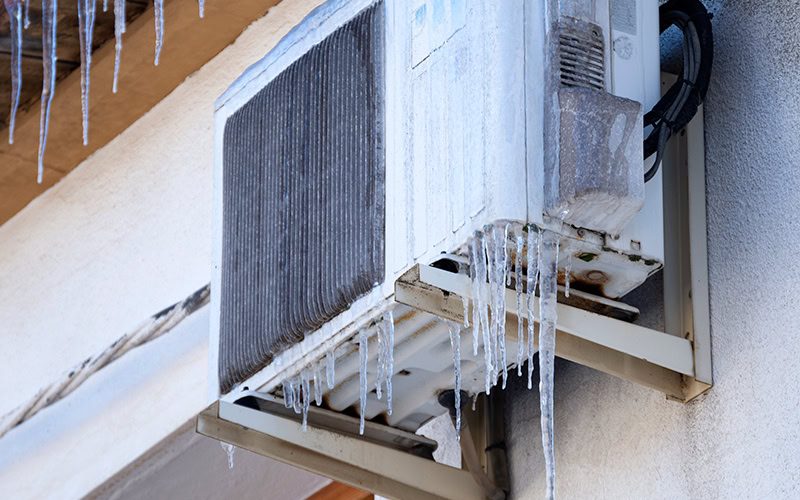 Why Is My Heat Pump Freezing Up? A heat pump covered in ice.