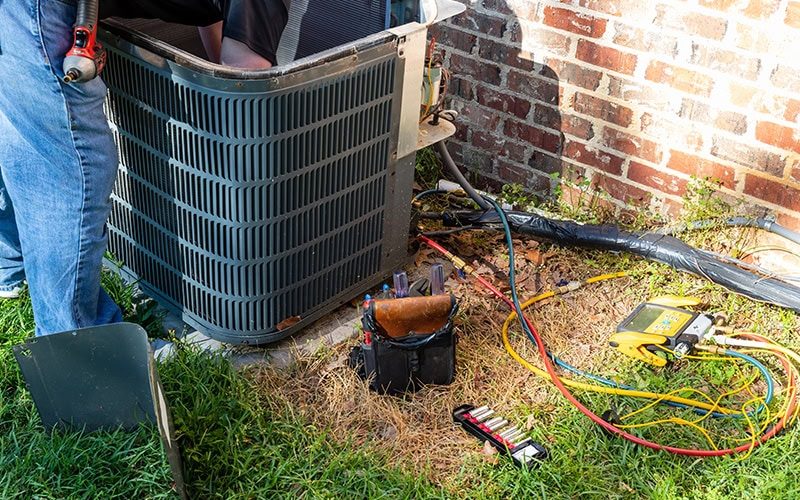 Air conditioner maintenance being performed.