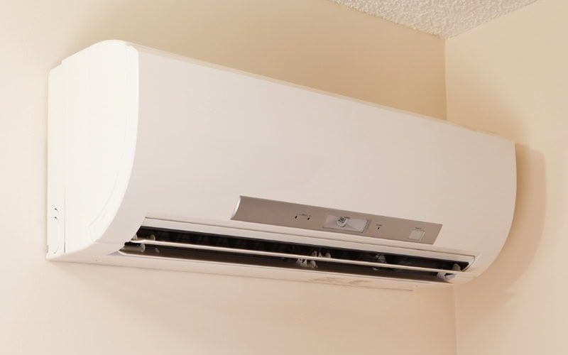 Why Are They Called Ductless Mini Splits? A wall-mount mini-split heating and air conditioning unit installed in a new house. A modern heat pump, this unit heats a house in winter and cools in the summer. This type of system eliminates ductwork which is a primary source of inefficiency in a conventional system making this about 30% more efficient. This particular unit has an eye sensor which pans the room looking for hot or cold spots and directs the airflow accordingly.