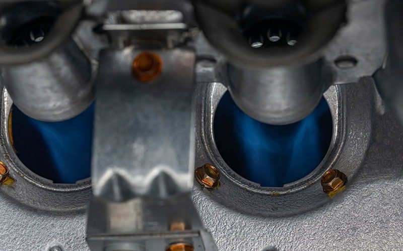10 Things to Consider When Buying a New Furnace. Close up photo of a gas furnace flame burner.