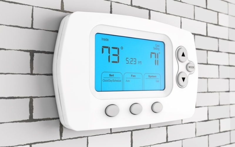 Thermostat Settings: On vs. Auto. Photo of digital thermostat.