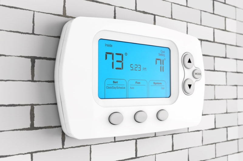 Thermostat Settings: On vs. Auto. Photo of digital thermostat.